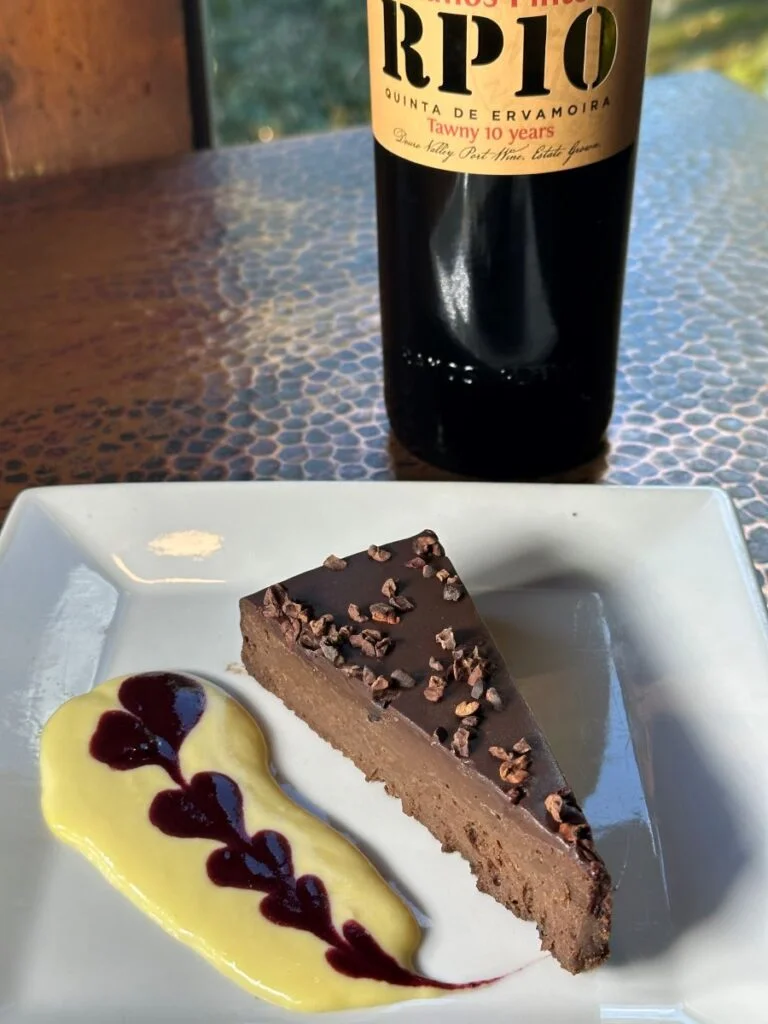 choclate cake presentation with bottle of red wine